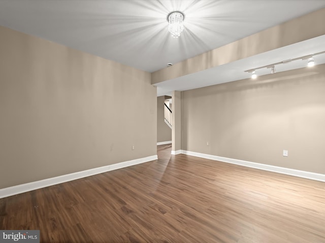 basement with a chandelier and hardwood / wood-style floors