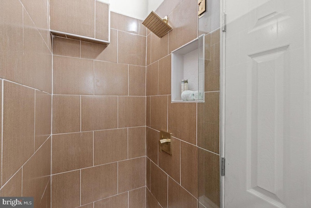 bathroom with tiled shower