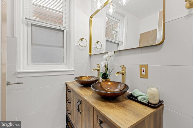 bathroom with vanity and tile walls