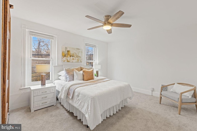 carpeted bedroom with ceiling fan and multiple windows