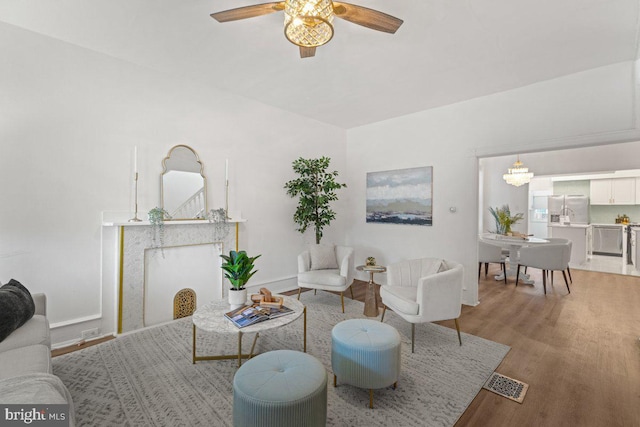 living room featuring ceiling fan and wood-type flooring