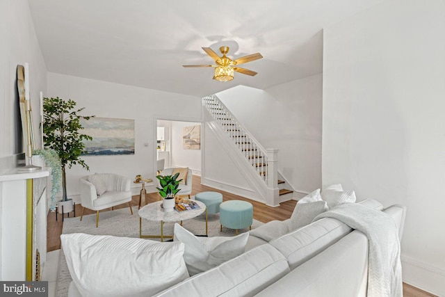 living room with ceiling fan and light hardwood / wood-style flooring