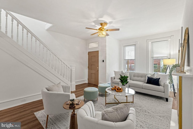 living room featuring ceiling fan and dark hardwood / wood-style flooring