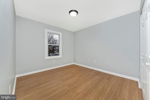 spare room with wood-type flooring