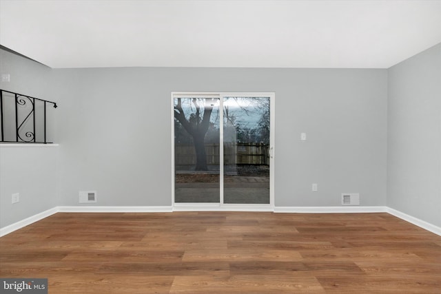 unfurnished room with hardwood / wood-style floors