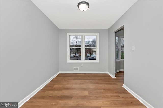 unfurnished room with wood-type flooring