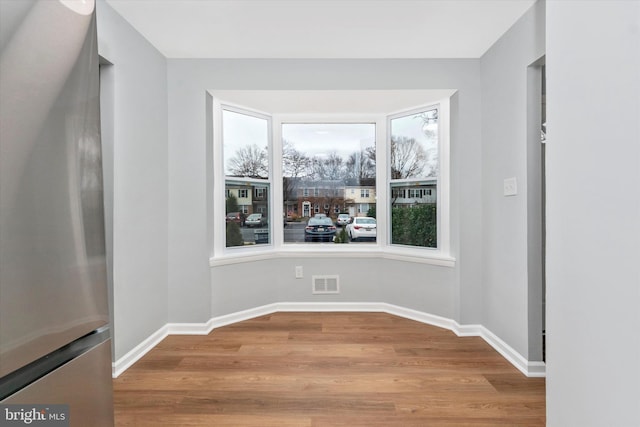 unfurnished dining area featuring light wood-type flooring