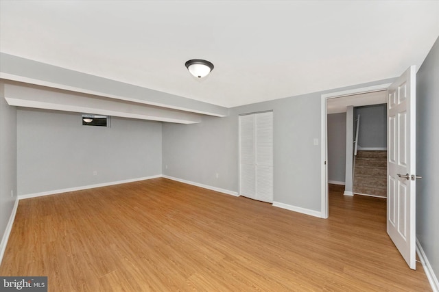 basement with light hardwood / wood-style floors