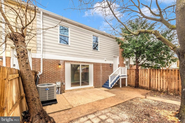 rear view of property featuring cooling unit and a patio area