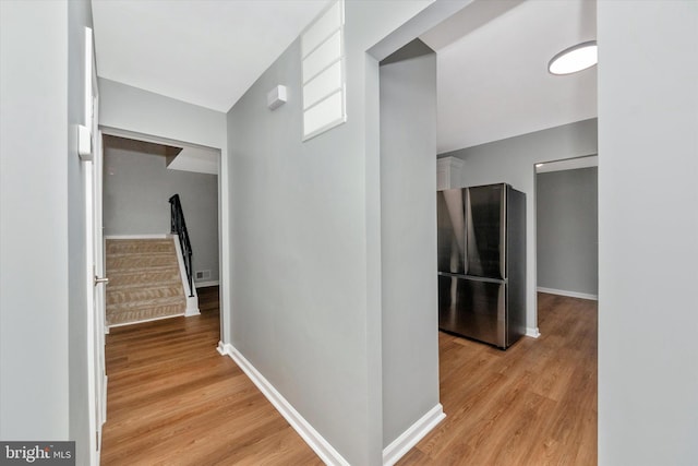 corridor with light hardwood / wood-style flooring