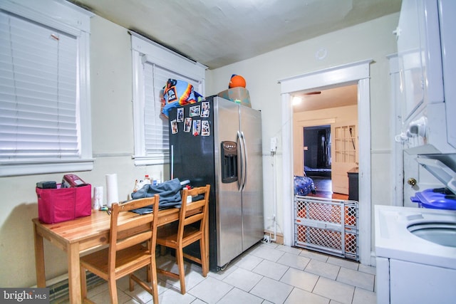 kitchen featuring white cabinets and stainless steel refrigerator with ice dispenser