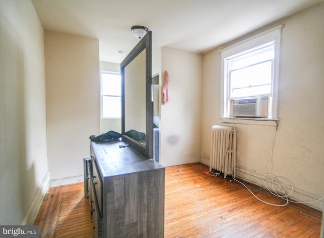 office area featuring light hardwood / wood-style floors, radiator, and cooling unit