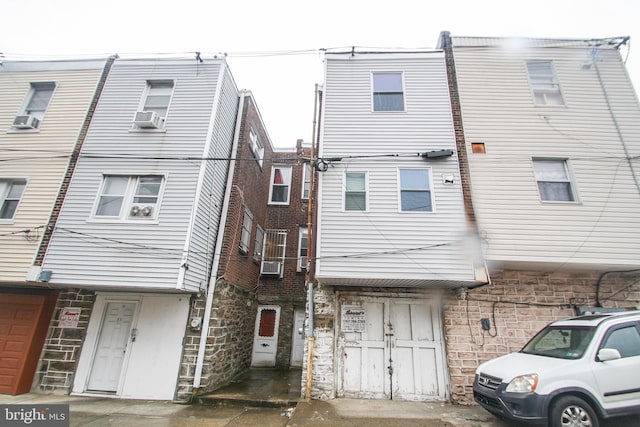 rear view of property featuring cooling unit