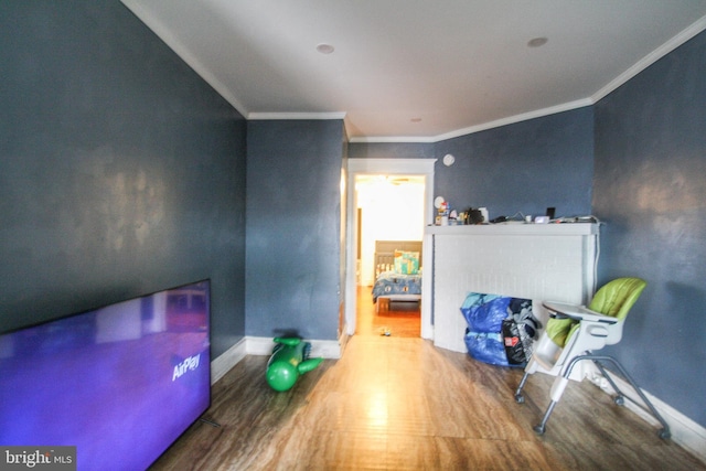 interior space with wood-type flooring and crown molding