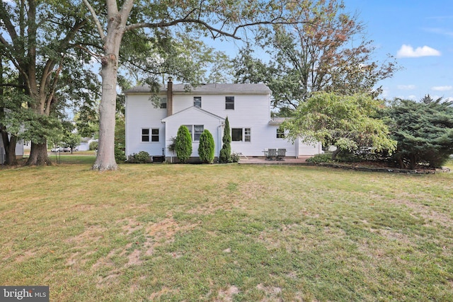 back of house with a patio, central air condition unit, and a lawn