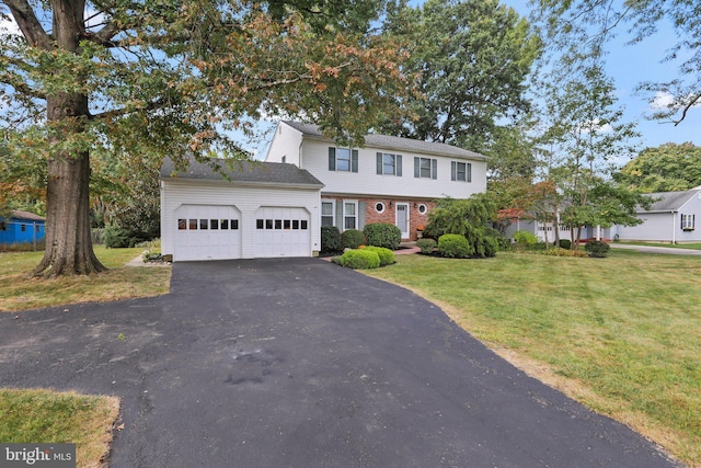 view of front of property featuring a garage and a front yard