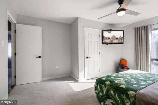 bedroom with ceiling fan and light colored carpet