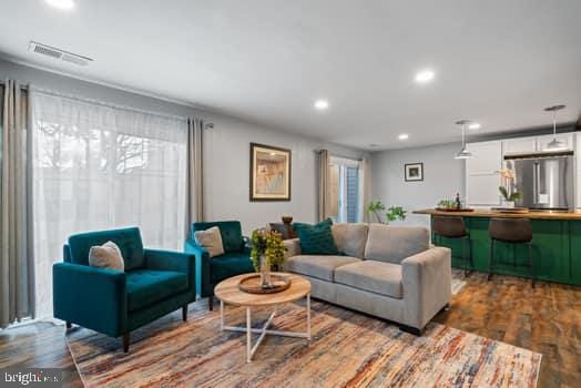 living room with hardwood / wood-style floors and a healthy amount of sunlight