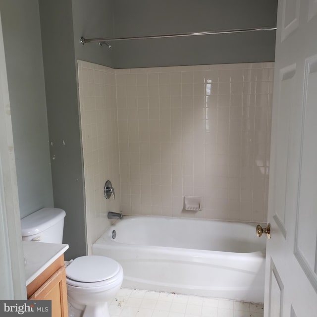 full bathroom featuring toilet, tile patterned floors, vanity, and tiled shower / bath combo