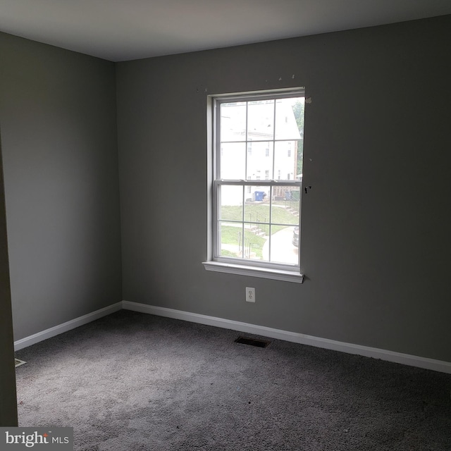 spare room featuring carpet