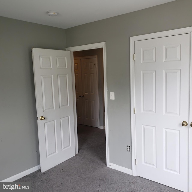 unfurnished bedroom featuring light carpet