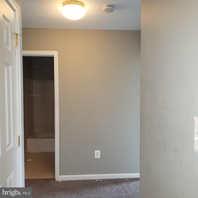 empty room featuring dark carpet