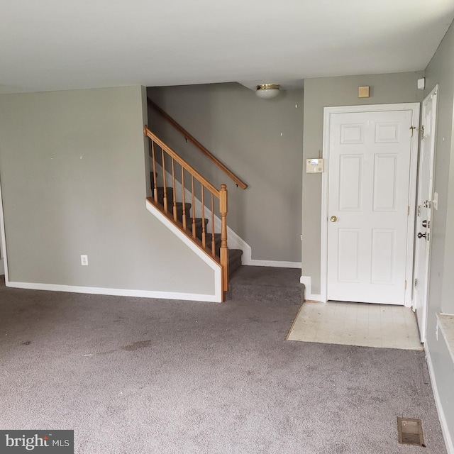 entrance foyer with carpet floors