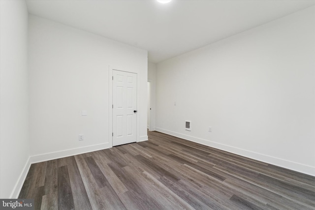 spare room with dark hardwood / wood-style floors