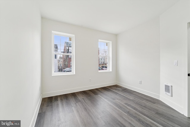 empty room featuring dark wood-type flooring