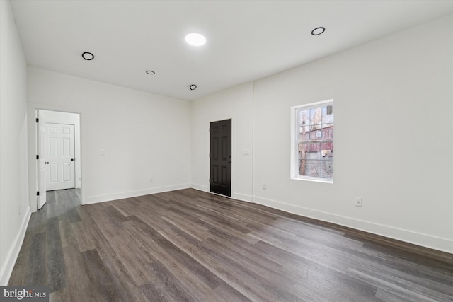 spare room with dark hardwood / wood-style flooring