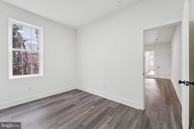 empty room with dark wood-type flooring