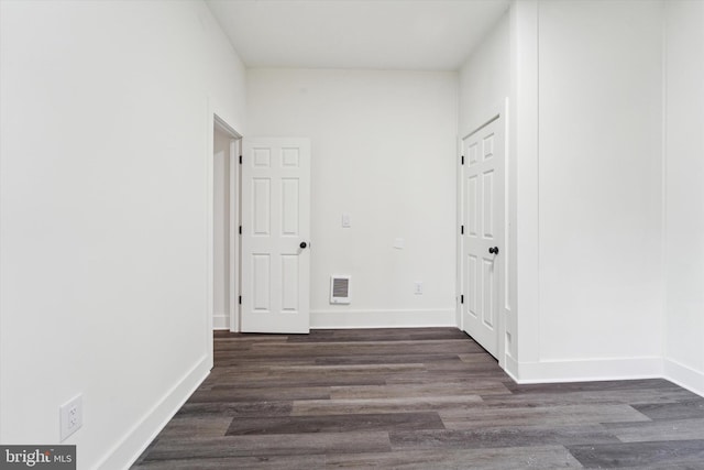 hall with dark wood-type flooring