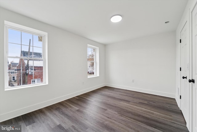 unfurnished bedroom with dark wood-type flooring