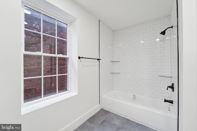 bathroom featuring tile patterned floors and tiled shower / bath