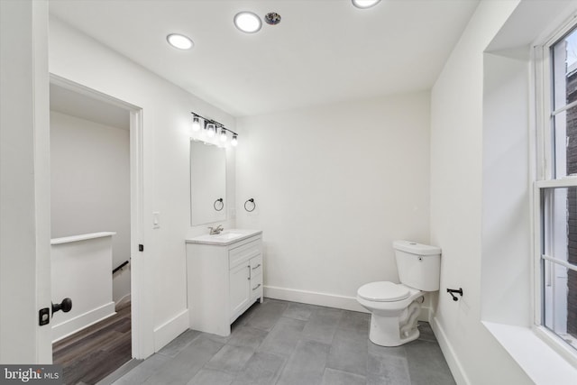 bathroom featuring hardwood / wood-style floors, vanity, and toilet