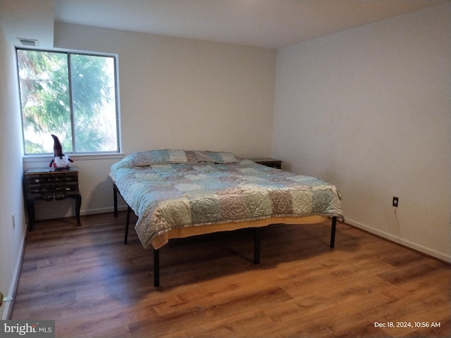 bedroom with wood-type flooring