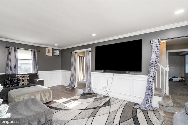 living room featuring wood-type flooring and ornamental molding