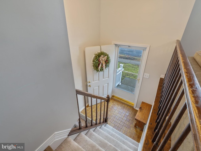 stairway with tile patterned flooring