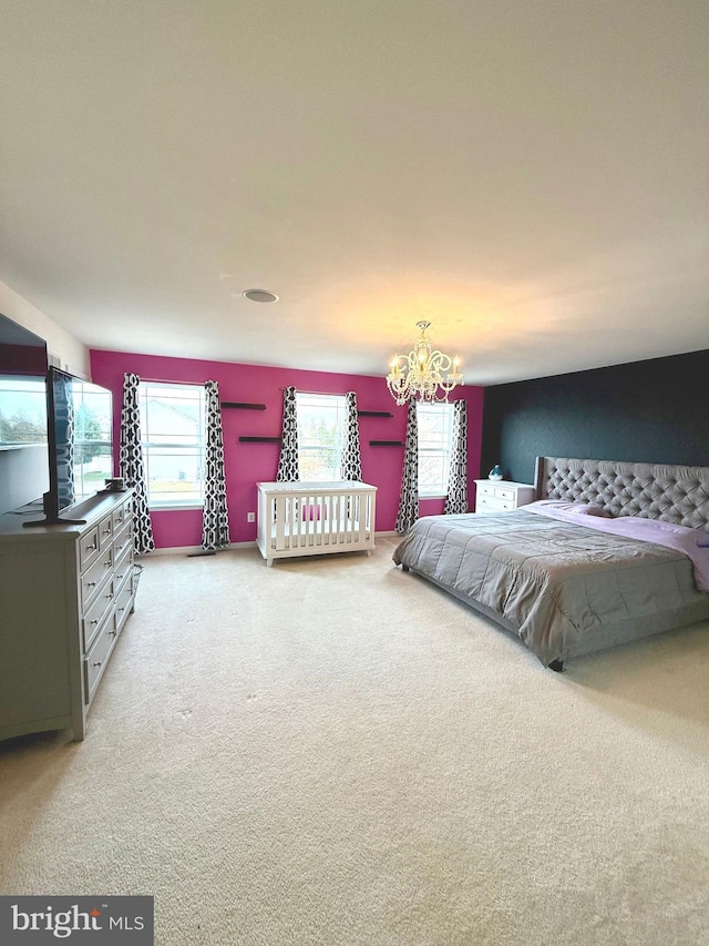 carpeted bedroom with an inviting chandelier