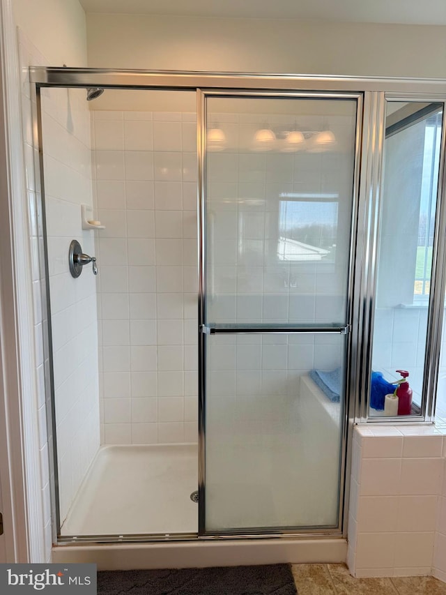 bathroom with a shower with door