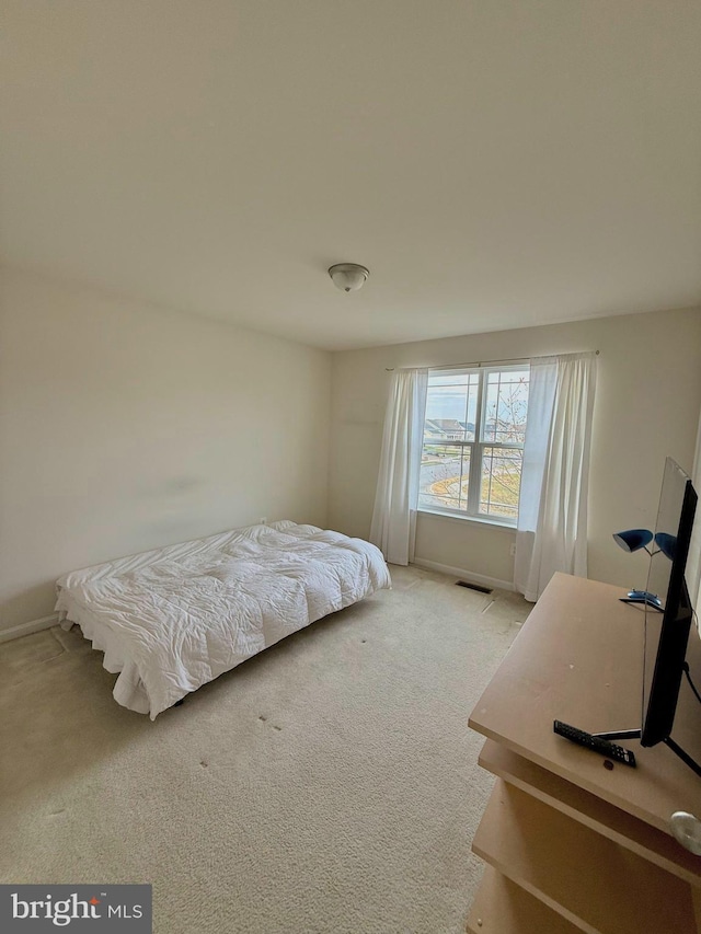 bedroom featuring light carpet