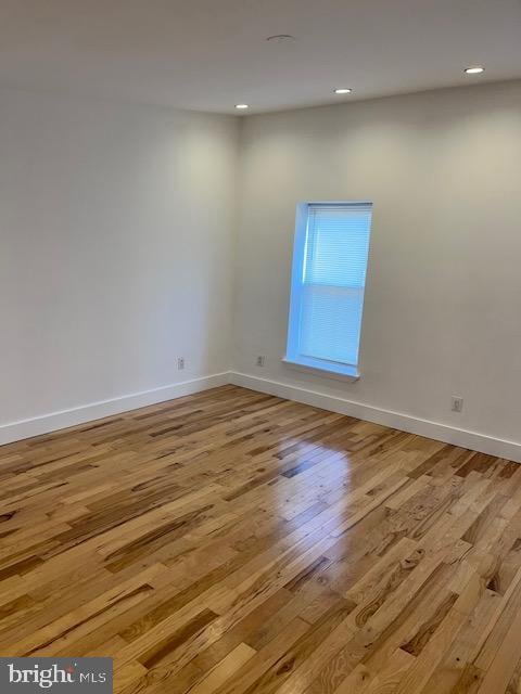 empty room with light hardwood / wood-style floors