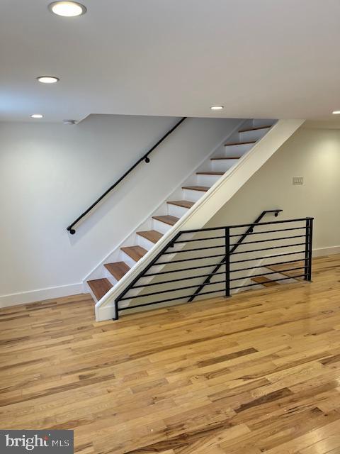 stairs featuring hardwood / wood-style flooring