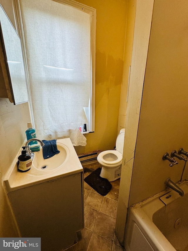 bathroom with tile patterned flooring, vanity, toilet, and a baseboard heating unit