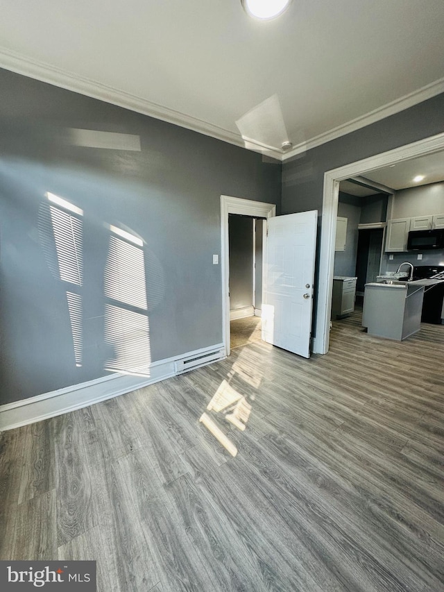 unfurnished living room with crown molding and light wood-type flooring