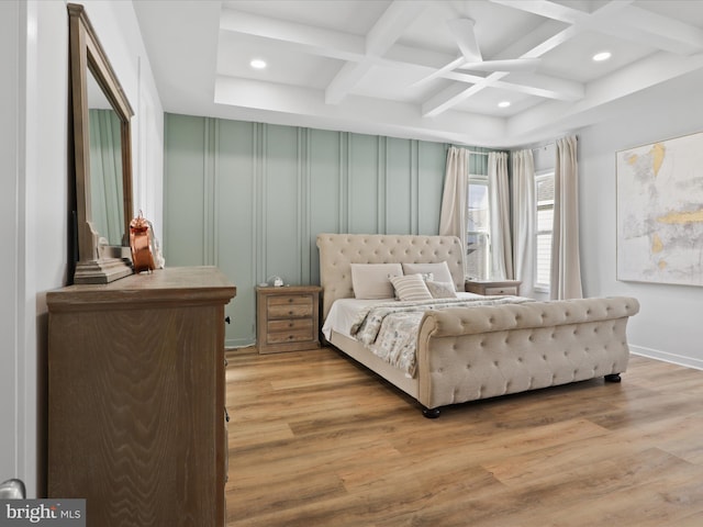 bedroom with beam ceiling, ceiling fan, light hardwood / wood-style flooring, and coffered ceiling