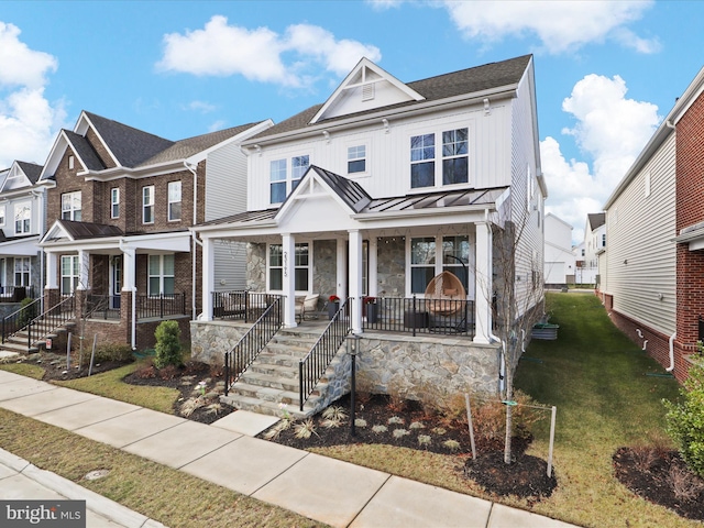 townhome / multi-family property with a front lawn and covered porch