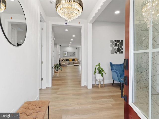 foyer featuring light hardwood / wood-style flooring and an inviting chandelier