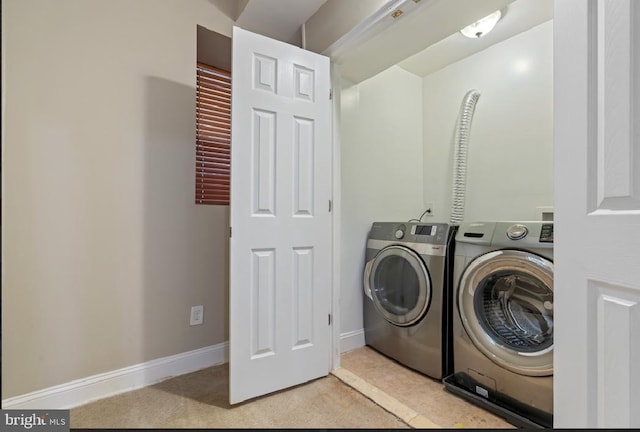 clothes washing area featuring light colored carpet and washing machine and clothes dryer