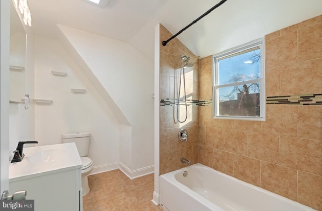 full bathroom featuring vanity, tile patterned floors, tiled shower / bath, vaulted ceiling, and toilet